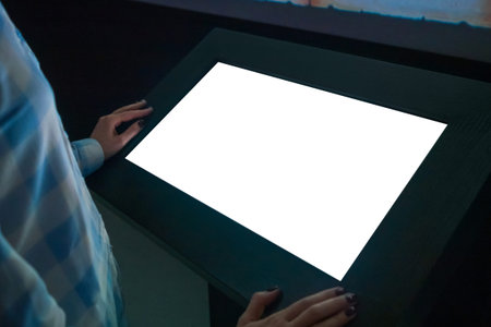 Mock up, copyspace, template, education, future and technology concept - woman looking at white blank interactive touchscreen display kiosk in dark room of modern technology museum - close up viewの写真素材