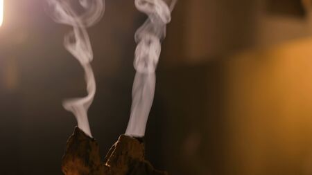 Incense stick burning with smoke during chinese tea ceremony. Relaxation, meditative and aromatherapy conceptの写真素材