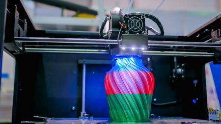 Automatic three dimensional 3D printer machine printing plastic model at modern technology exhibition. 3D printing, additive technologies, 4.0 industrial revolution and futuristic conceptの写真素材