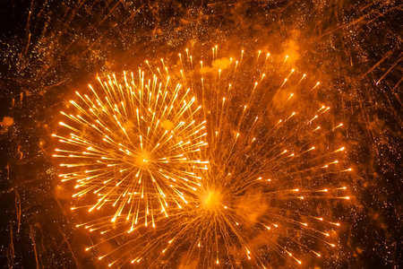 Colorful bright fireworks in dark sky at night. Evening time, low light illumination. Holiday,...