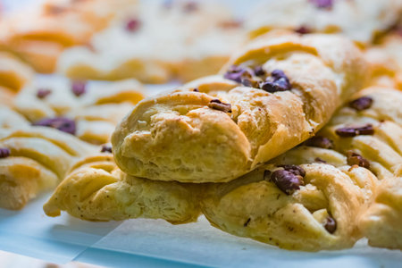 Assortment of delicious freshly baked sweet and puff pastry for sale on counter of shop, grocery,...