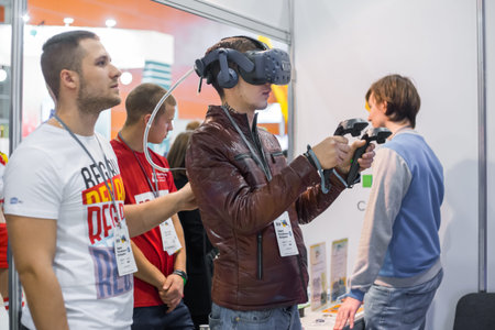 MOSCOW, RUSSIA - March 1, 2019: Virtual Reality Exhibition. Man using virtual reality headset and...
