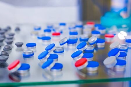 Caps, covers for medical glass bottles in showcase at pharmaceutical exhibition, pharmacy laboratory. Pharma industry, science, medicine, experiment and healthcare conceptの写真素材