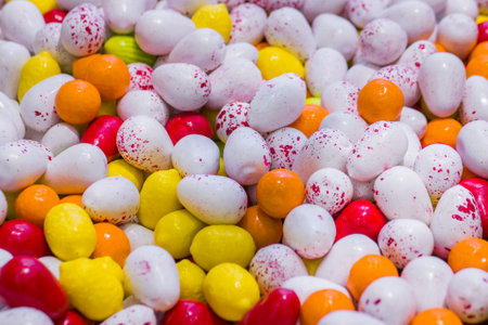 Colorful delicious glazed chocolate candies background, copy space, pattern. Dessert, sweet food and...
