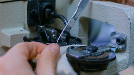 Professional male skinner, furrier working with mink fur skin at atelier, workshop. Fashion and leatherwork conceptの写真素材