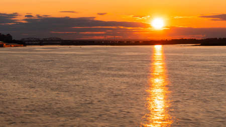 Dramatic colorful golden susnet on the Volga river. Evening time, warm illumination. Calm, peaceful, atmospheric view, relaxation conceptの写真素材