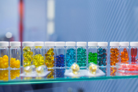 Colorful medical capsules, pills, vitamins, tablets, drugs, meds in clear plastic bottle for sale at...