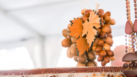Wooden grapes and foliage - handmade art object at souvenir market