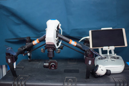 Drone with remote control. Professional quadcopter for making aerial photo at emergency services...
