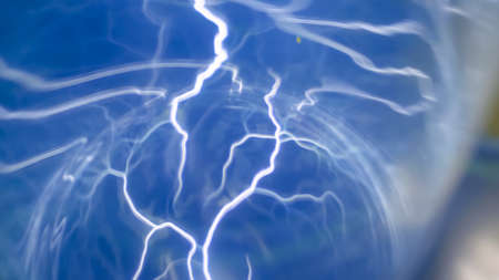 Plasma ball with many energy rays inside, blue illumination - close up view. Electricity, education, science, futuristic and physics conceptの写真素材