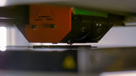 Print head of 3D printer machine printing plastic model at modern scifi technology exhibition,...