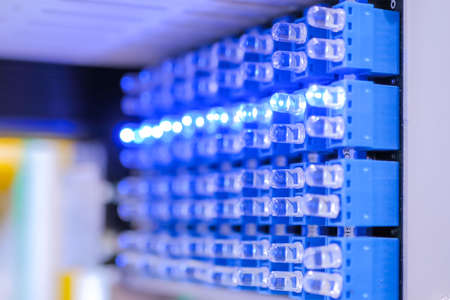 Blue lighting status indicator signals on electric control panel of automation machine equipment on fabric, exhibition - close up view. Industrial, manufacturing, electronic conceptの写真素材