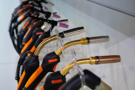 Row of welding torches at exhibition, trade show - close up. Safety, industry, equipment, technology...