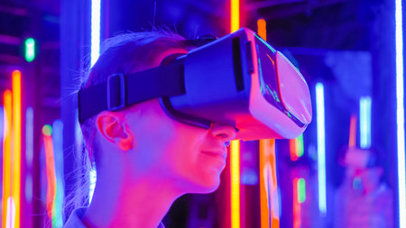 Woman using virtual reality headset and looking around at interactive technology exhibition with...
