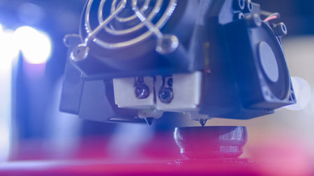 3D printer prints physical plastic model at modern technology exhibition, factory - close up....