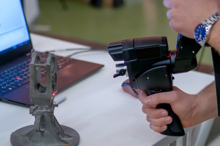 Close up view of man hand holding handheld 3d scanner for capturing object at modern technology...