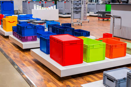 Many colorful plastic boxes, containers, crates at storage, warehouse, exhibition, trade show. Recycling, logistic and trade conceptの写真素材