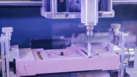 Automated milling machine cutting wooden workpiece from wood pulp, making 3d model at technology exhibition, factory - close up. Woodworking, CNC engraving, carving, industrial, manufacturing conceptの写真素材