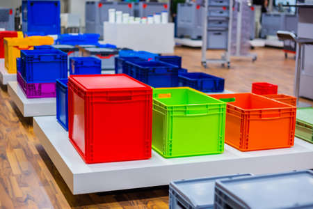 Many colorful plastic boxes, containers, crates at storage, warehouse, exhibition. Recycling, logistic and trade conceptの写真素材