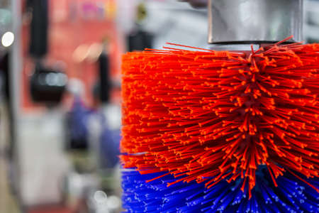 Close up: automatic red and blue swinging brush for cleaning cows at agricultural exhibition. Farming, industrial, agriculture industry, care, animal husbandry conceptの写真素材
