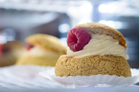 Assortment of delicious fresh cakes with cream and berries on counter for sale at restaurant, cafe, bakery. Dessert, culinary, sweet food and confectionery conceptの写真素材