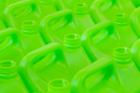 Many empty green plastic jerrycans background in warehouse, market, factory or exhibition - close up