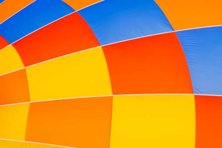 Colorful envelope of the hot air balloon during inflation stage - preparing for launch at outdoor aerostat festival - close up. Freedom, aviation, sport conceptの写真素材