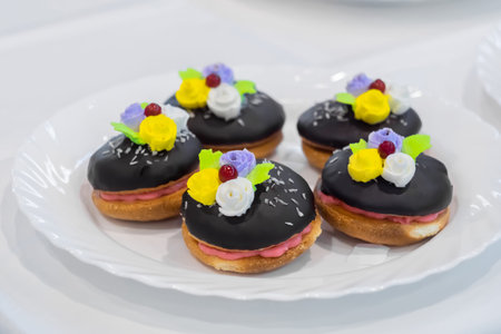 Close up: assortment of delicious fresh shortcrust tart cakes with cream and chocolate on white plate for sale at restaurant, cafe, bakery. Dessert, culinary, sweet food and confectionery conceptの写真素材