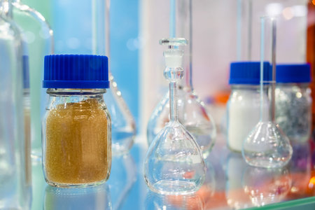 Medical glass bottles in showcase at pharmaceutical exhibition, pharmacy laboratory - close up....