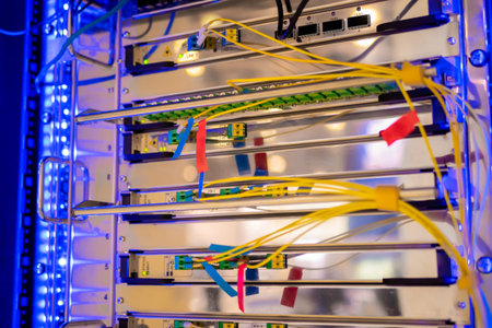 Telecommunication technology equipment - fiber optic cables and switch at server room, data center -...