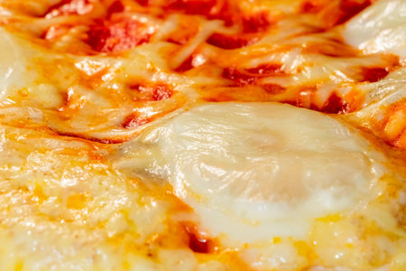 Baked pizza Margherita with mozzarella cheese and tomato ketchup in electric oven - close up, macro....