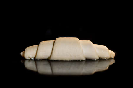 Uncooked croissant on tray in electric oven - close up view, black background. French cuisine, homemade bakery, breakfast, food, cooking, pastry, semi-finished products and raw conceptの写真素材