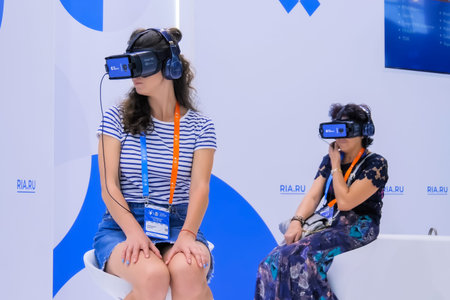 MOSCOW, RUSSIA - JANUARY 5, 2020: Interactive VR exhibition. Two women using virtual reality headset...