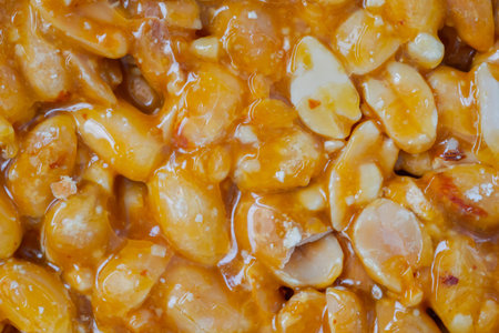 Top view: caramelized nuts fried in honey - Gozinaki - orange granola peanut bar - close up, macro....