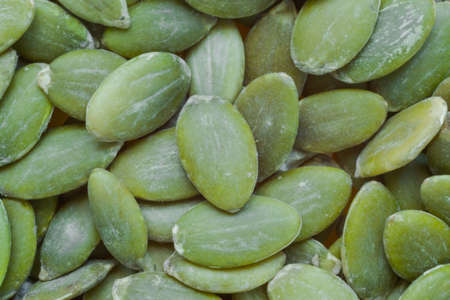 Top view: heap of uncooked green pumpkin seed - close up, macro. Healthy food conceptの写真素材