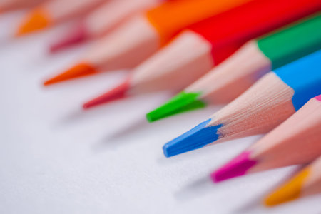 Many different colored pencils on white surface - close up, selective focus, macro. Abstract,...