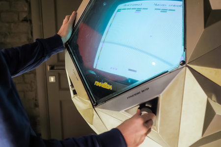 MOSCOW, RUSSIA - JUNE 15, 2020: Soviet Arcade Machine Museum. Man gamer hands playing vintage...