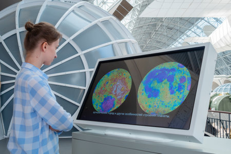MOSCOW, RUSSIA - JANUARY 5, 2020: Cosmonautics and Aviation Centre. Portrait of woman in blue plaid shirt looking at interactive touchscreen display of electronic kiosk. Education, technology conceptのeditorial素材