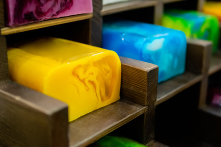 Handmade multicolored natural soap on counter of eco-friendly shop - close up. Spa, cosmetic, treatment, skincare and aromatherapy conceptの写真素材