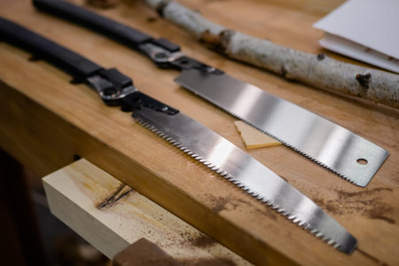 Handmade steel knives on wooden counter of market, trade show - close up. Design, handmade and sale...