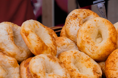 Fresh bread rolls with sesame seeds at street food festival - close up. Outdoor cooking, gastronomy, takeaway food and bakery conceptの写真素材