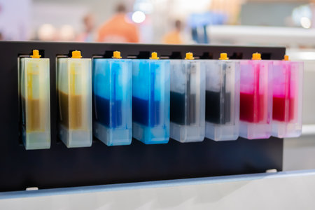 Row of inkjet printer CMYK cartridges - cyan, magenta, yellow, key or black colors - close up view.の写真素材