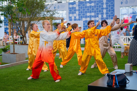 MOSCOW, RUSSIA - JANUARY 5, 2020: Social innovation exhibition. Group of people doing qigong exercise together. Wellness, spiritual, relaxation, praticing, sport, training and martial arts conceptのeditorial素材
