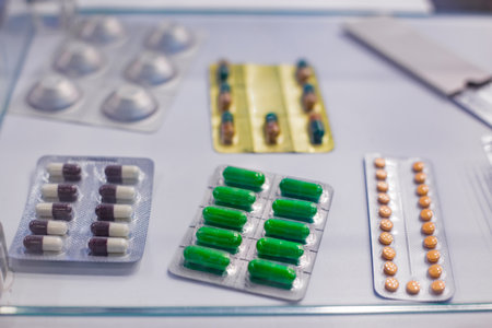Medical capsules, pills, tablets, drugs, meds in blister pack for sale at pharmacy drug store, pharmaceutical exhibition. Pharma industry, medicine and healthcare conceptの写真素材