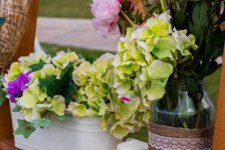 Pots with beautiful blooming flowers on wooden shelf at summer festival - close up view. Floristry, outdoor decor, artwork and decoration conceptの写真素材