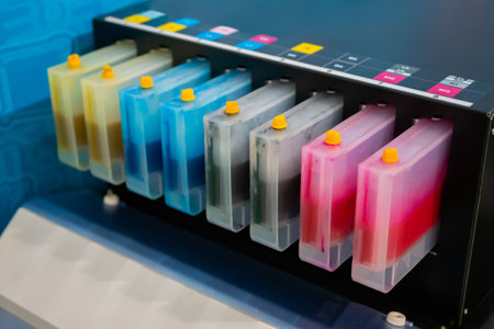 Row of inkjet printer CMYK cartridges - cyan, magenta, yellow, key or black colors - close up view.の写真素材