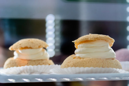 Assortment of delicious fresh cakes with cream on counter for sale at restaurant, cafe, bakery. Dessert, culinary, sweet food and confectionery conceptの写真素材