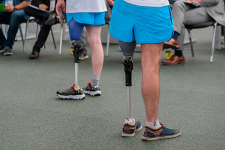 MOSCOW, RUSSIA - JUNE 25, 2019: Exhibition for Rehabilitation. Group of people standing at adaptive sport competition for disabled persons with leg prosthesis: close upのeditorial素材