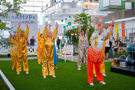 MOSCOW, RUSSIA - JANUARY 5, 2020: Social innovation exhibition. Group of people doing qigong exercise together. Wellness, spiritual, relaxation, praticing, sport, training and martial arts conceptのeditorial素材