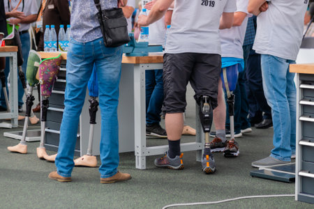 MOSCOW, RUSSIA - JUNE 25, 2019: Exhibition for Rehabilitation. Group of people standing at adaptive sport competition for disabled persons with leg prosthesis: close upのeditorial素材